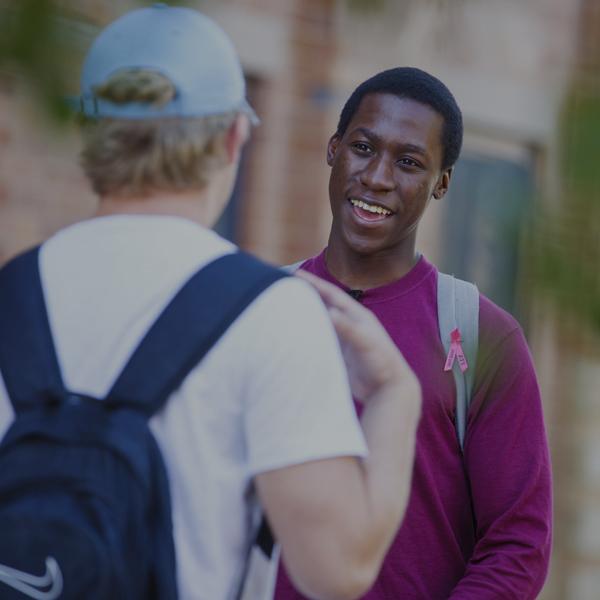 Students talking in front of the College of Business building.